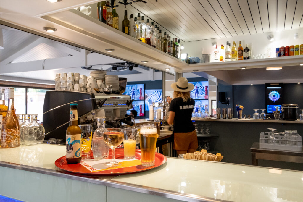 Oasis Village snack bar counter in Puget-sur-Argens, with a tray of drinks and a coffee machine